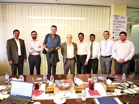Total’s Christophe Gerondeau, fourth left, and Marc Delaunay, third left, with Quality International’s senior management team, during an appreciation visit to the company’s headquarters in the UAE