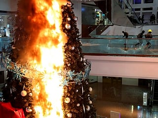 Protesters set Christmas tree on fire at a Hong Kong luxury mall
