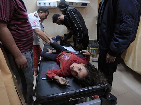Palestinian medical workers tend to wounded children, members of a family where six were killed in an Israeli airstrike, in central Gaza Strip's Deir al-Balah on November 14, 2019. 