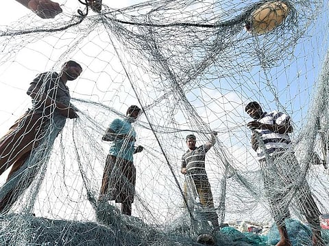 Fishermen preparing their fishing nets at Al Khan Area Sharjah.