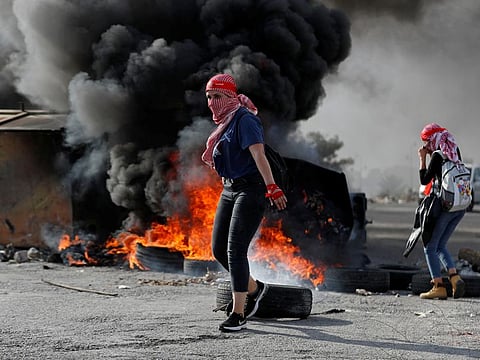 Palestinians protest near the Jewish colony of Beit El in the Israeli-occupied West Bank on November 16, 2019. 