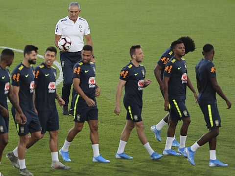 Brazil's head coach Tite (white) with his players during a practice session in Abu Dhabi ahead of their friendly against South Korea.