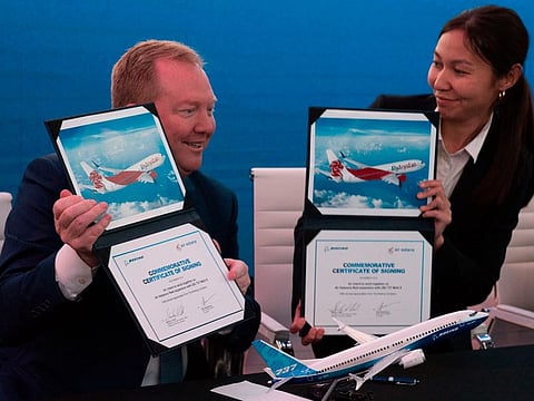 Boeing Commercial Airplanes president and CEO Stanley A. Deal, left, and Air Astana chief planning officer Alma Aliguzhinova pose at a news conference at the Dubai Airshow in Dubai, United Arab Emirates, Tuesday, Nov. 19, 2019. Kazakhstan's national carrier Air Astana announced Tuesday a letter of intent to purchase 30 of Boeing's 737-8 Max jets for its new budget airliner FlyArystan. (AP Photo/Jon Gambrell)