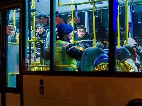 A bus with refugees drives away from the DFDS ferry, in the harbour of Vlaardingen, Netherlands on November 19, 2019, after 25 stowaways were found on board.