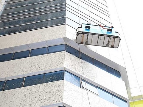  Lieutenant Colonel Raed Obaid Al Zaabi, Director of Centres Department at Ajman Civil Defense, said they received a report at 9am saying that two people were stuck on a window cleaning platform on the side of a tower in Ajman.