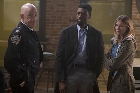 (L-r) J.K. Simmons, Chadwick Boseman and Sienna Miller  in “21 Bridges.” MUST CREDIT: Matt Kennedy/STXfilms