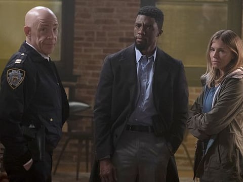 (L-r) J.K. Simmons, Chadwick Boseman and Sienna Miller  in “21 Bridges.” MUST CREDIT: Matt Kennedy/STXfilms
