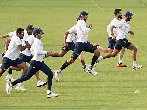 Indian team members warm up during a training session ahead of their second cricket test match against Bangladesh, in Kolkata, on Wednesday. 