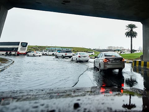 Vehicles crawling through a flooded street in Sharjah on Wednesday.