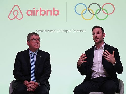 International Olympic Committee (IOC) President Thomas Bach (L) and Airbnb co-founder Joe Gebbia speak at an event in London to announce Airbnb as a leading partner of the Olympics on November 19, 2019.