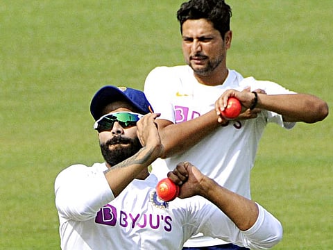 Indian Players Ravindra Jadeja and Kuldeep Yadav practise with the pink ball ahead of India's first day-night test match against Bangladesh at Eden Gardens in Kolkata on Thursday. 