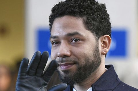 FILE - In this March 26, 2019 file photo, former “Empire” actor Jussie Smollett smiles and waves to supporters before leaving Cook County Court after his charges were dropped in Chicago. Smollett says his $10,000 payment after the close of a criminal case should prevent Chicago from seeking reimbursement for a police investigation of his claim that he was a victim of a racist and homophobic attack. Smollett’s attorneys filed a response to Chicago’s lawsuit. They also filed a counterclaim against the city, saying Smollett was the victim of a malicious prosecution. Smollett told police he was beaten by two men. Police said it was staged.(AP Photo/Paul Beaty, File)