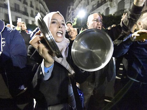 Algerians shout slogans and march in the streets of the capital Algiers as they participate in a night demonstration against the upcoming presidential election, on November 21, 2019. 