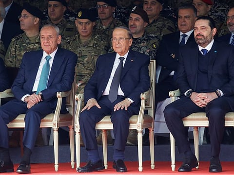 Lebanese Speaker of the Parliament Nabih Berri, Lebanon's President Michel Aoun and caretaker Prime Minister Saad al-Hariri attend a military parade to mark the 76th anniversary of Lebanon's independence at the Ministry of Defense in Yarze, Lebanon November 22, 2019. 