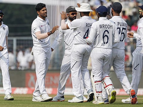 Indian fast bowler Umesh Yadav being congratulated by his teammates after India wrapped up the day-night Test match against Bangladesh in Kolkata on Sunday.