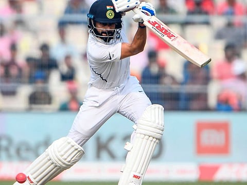 Indian skipper Virat Kohli launches into a trademark cover drive during his century in the Pink-ball Test at the Eden Gardens.