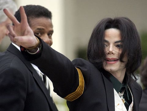 In this March 2, 2005, file photo, pop icon Michael Jackson waves to his supporters as he arrives for his child molestation trial at the Santa Barbara County Superior Court in Santa Maria, Calif.