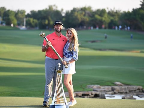 Jon Rahm of Spain with his fiancee, Kelley Cahill, after winning the DP World Tour Championship and Race to Dubai titles at the Jumeirah Golf Estates today.
