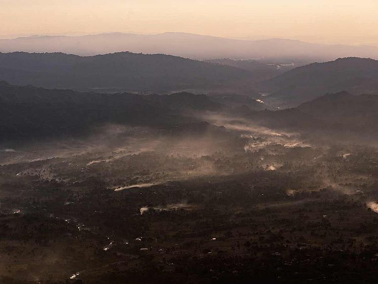 Smoke rises as farmers set fire to clear their fields after harvest in the Kangra Valley in Dharmsala, India, Sunday, Nov. 24, 2019.