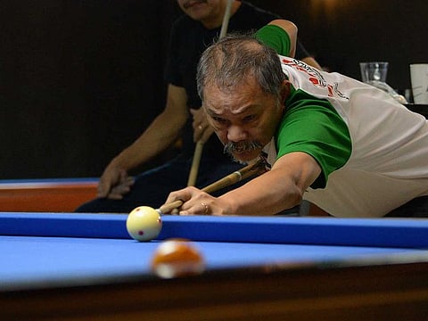 Filipino Efren 'The Magician' Reyes, a multiple world champion, plays pool at a billiard hall in Manila.