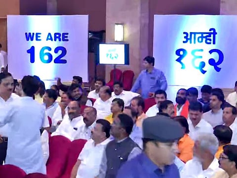 A graphic showing 'We Are 162' is seen during a meeting of Shiv Sena-NCP-Congress leaders with MLAs at Hotel Grand Hyatt in Mumbai on Monday