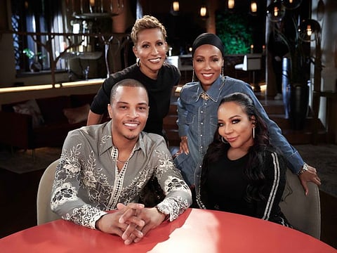 Rapper T.I., seated at left, Gammy, Jada Pinkett Smith and Tiny pose for a photo promoting their "Facebook Red Table Talk." MUST CREDIT: Photo by Michael Becker
