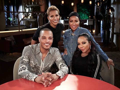 Rapper T.I., seated at left, Gammy, Jada Pinkett Smith and Tiny pose for a photo promoting their "Facebook Red Table Talk." MUST CREDIT: Photo by Michael Becker