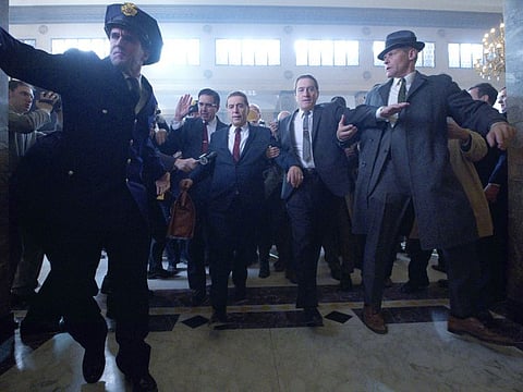 Teamster lawyer Bill Bufalino (Ray Romano) and Frank Sheeran (Robert De Niro) escort Jimmy Hoffa (Al Pacino) to court. 