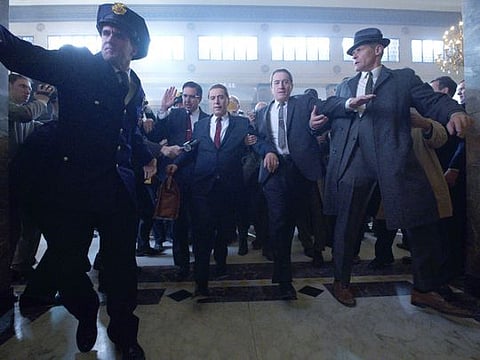 Teamster lawyer Bill Bufalino (Ray Romano) and Frank Sheeran (Robert De Niro) escort Jimmy Hoffa (Al Pacino) to court. 