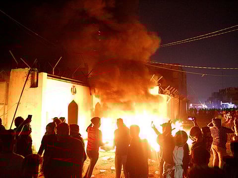 Demonstrators set fire in front of the Iranian consulate, as they gather during ongoing anti-government protests in Najaf, Iraq November 27, 2019.
