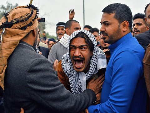 An Iraqi mourner reacts during a funeral procession for anti-government demonstrators killed during protests a day earlier, in the central holy shrine city of Najaf on November 29, 2019. 