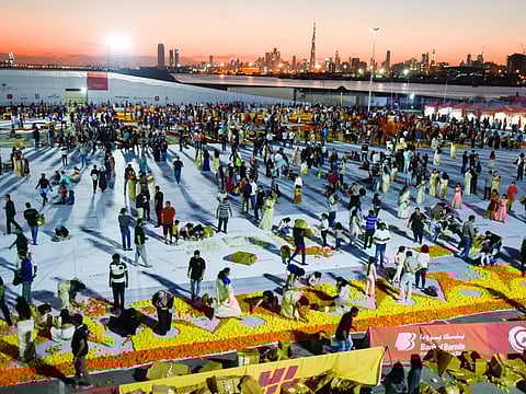 People of different nationalities create the largest natural flower carpet to showcase the UAE's tolerance and unity of its residents at Dubai Festival city on Friday 22 November 2019