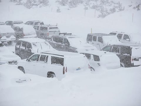 This Tuesday, November 27, 2019 photo provided by the Mammoth Mountain Ski Area shows parked SUVs covered in snow at Mammoth Mountain in Mammoth Mountain, Calif. Blizzard conditions have closed Interstate 5 south of Ashland, Oregon, all the way to the California state line. The Siskiyou Summit at the border on I-5, typically one of the more perilous sections of freeway along the West Coast corridor in wintery weather, had seen 6 inches of new snow with 10 inches packed on the roadside. 