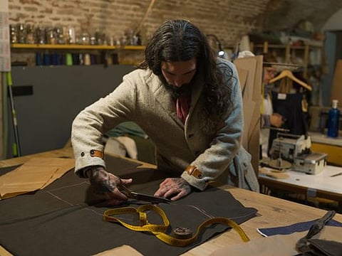Fernando García de la Calera, who specializes in custom-made jeans, works at the Concrete in Madrid, Nov. 13, 2019. In the Spanish capital, shoppers looking for high-quality clothes and accessories can still find them — or have them made to order. (Samuel Aranda/The New York Times)