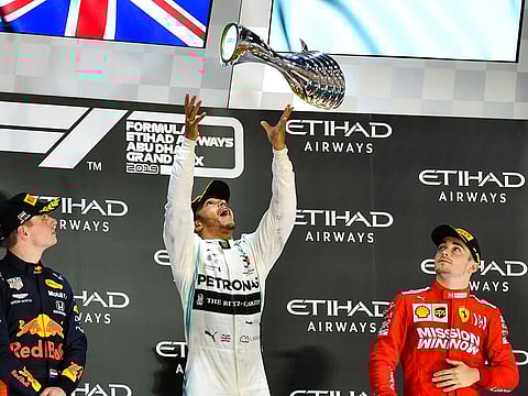 Lewis Hamilton celebrates on the podium in Abu Dhabi.