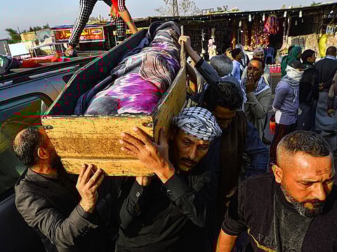 Iraqi mourners carry the coffin of an anti-government protester who was killed in Nasiriyah during clashes between anti-government protesters and security forces.
