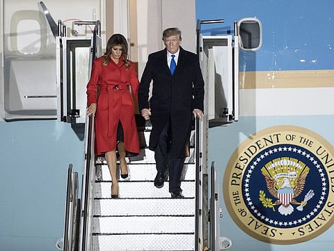 U.S. President Donald Trump, right, and U.S. First Lady Melania Trump disembark from Air Force One after arriving at London Stansted Airport in Stansted, U.K., on Monday, Dec. 2, 2019. 