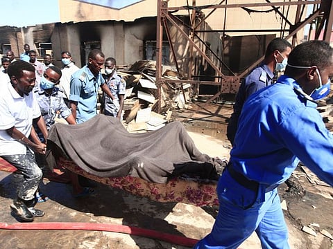 EDITORS NOTE: Graphic content / Members of the Sudanese Civil Defence transport the bodies of victims of a fire at a tile manufacturing unit in an industrial zone in north Khartoum, on December 3, 2019. 