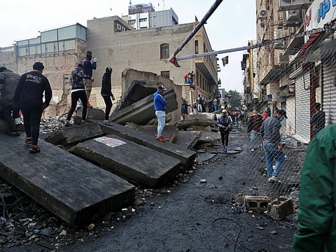 Protesters gather while security forces close River Street during ongoing anti-government protests in Baghdad, Iraq, Monday, Dec. 2, 2019. 