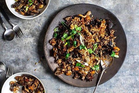 Sweet Spiced Mushroom and Rice Pilaf, in New York, on Nov. 12, 2019. To elevate rice to the center of the holiday table, Yotam Ottolenghi bakes it in fragrant stock, with mixed mushrooms. (Andrew Scrivani/The New York Times)