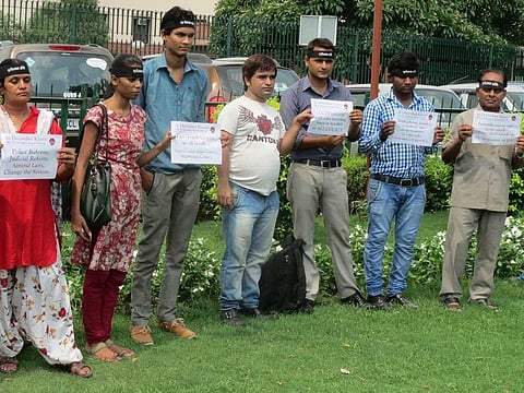 Activists demonstrate against Indian Supreme Court's stay on the death sentence awarded to two of the four men in the December 16 gang-rape and murder case in New Delhi on July 16, 2014. 