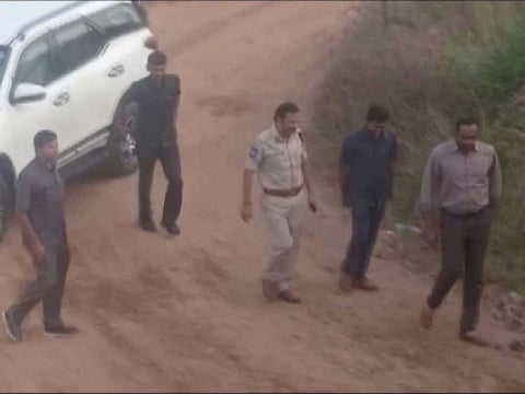 Still frame taken from December 6, 2019 video shows Police Commissioner V.C. Sajjanar and other police officials arriving at a spot where police shot dead four men suspected of raping a veterinary doctor, in Hyderabad, Telangana, India. 