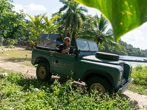 Daniel Craig as James Bond in his Land Rover Series III in Jamaica