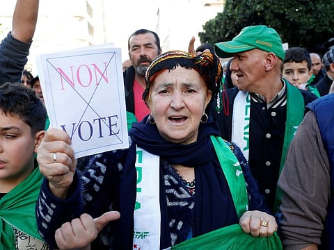 Demonstrators take part in a protest to demand for the presidential election scheduled for next week to be cancelled, in Algiers, Algeria, December 6, 2019. 