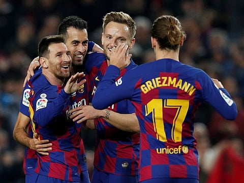 Lionel Messi of Barcelona being congratulated by teammates on reaching his 35th La Liga hattrick, against Real Mallorca, on Saturday.