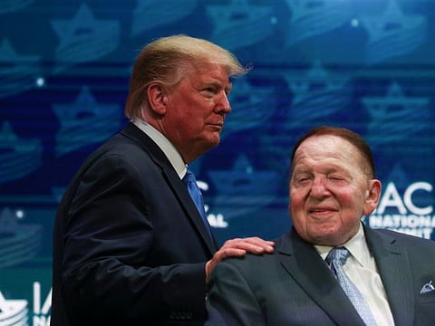 U.S. President Donald Trump greets Sheldon Adelson while taking the stage at the Israeli American Council National Summit in Hollywood, Florida, U.S., December 7, 2019. 