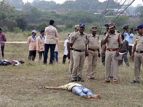 Bodies of the accused in the rape and murder of the veterinarian seen at the spot where they were killed in an "encounter" with the police. 