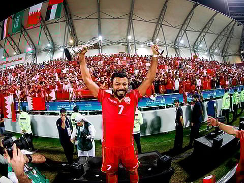 Bahrain midfielder Mohamed Abdulwahab celebrates with the Gulf Cup trophy.