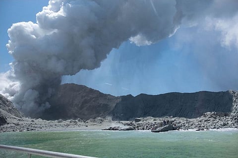 The volcano on New Zealand's White Island spewing steam and ash minutes following an eruption