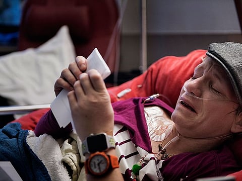 Marieke Vervoort, whose long-planned euthanasia was ultimately still more than a year away, weeps to read a farewell letter from a friend during a hospitalization in Diest, Belgium, Jan. 9, 2018. Knowing she had the legal right to die helped Vervoort live her life. It propelled her to medals at the Paralympics. But she could never get away from the pain.
